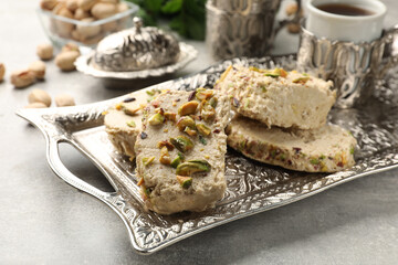 Tasty pistachio halva served on light grey table, closeup - obrazy, fototapety, plakaty
