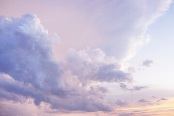 Blue purple lilac orchid pink peach white orange gold yellow cloudy evening sky background. Sunset...
