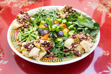 Serving of vegetarian yusheng made up of healthy organic vegetables and herbs for Chinese New Year celebration