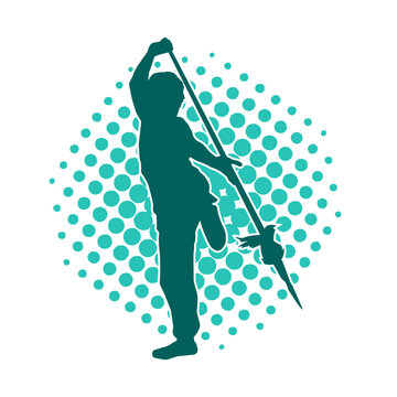 Silhouette of a martial art person in action pose with spear weapon. Silhouette of a fighter male using spear weapon in battle pose.