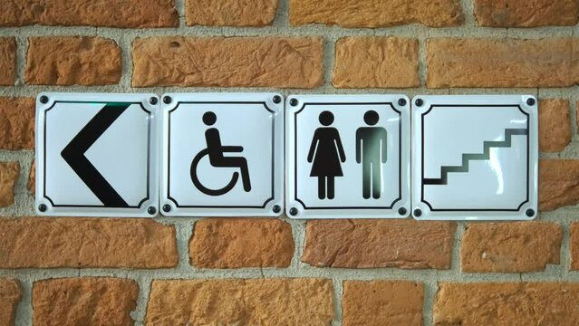 Signboard handicap toilet sign, toilet for people with disabilities. Female and male symbols on plates for public toilets, water closets. Sign. pointer. toilet or WC.