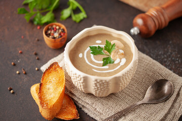 Homemade mushroom cream soup in bowl on the table.