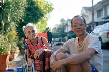 asian son and old mother happiness with relaxing time at home village