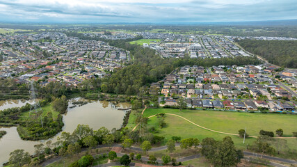 Fototapeta na wymiar Drone aerial photograph of residential houses and recreational spaces in the suburb of Glenmore Park in the greater Sydney region in New South Wales in Australia