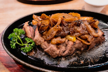 Restaurant food as beef steak on a hot plate,  Protein platter with savory sauce