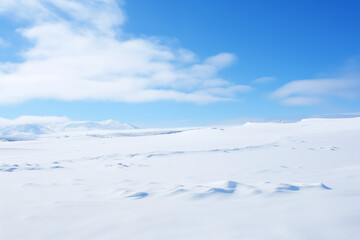 Winter background picture of blue sky, white clouds and blank snow