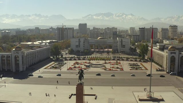 A bird's-eye view of Bishkek. Beautiful snow-capped mountains. The building of the Office of the State Tax Service of Bishkek. Monument to Manas. Travel to Kyrgyzstan.