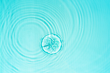 Blue transparent water texture with circles from drops Abstract summer background in turquoise...