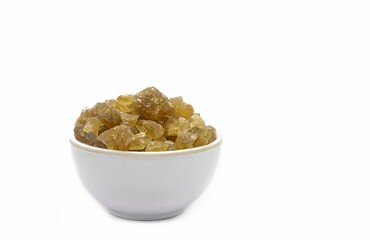 Tal Mishri or Palm Sugar  in a White Bowl Isolated on White Background with Copy Space in Horizontal Orientation, Also Known as Rock Sugar