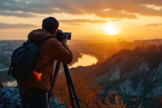 A man is using a camera to capture a beautiful sunset