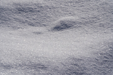 Fallen snow as a background. Uneven surface.  Texture of fresh clean snow. Place for text.