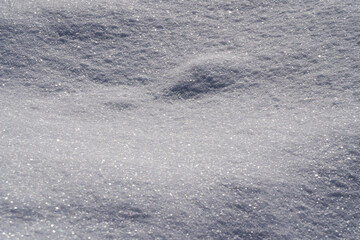 Obraz premium Fallen snow as a background. Uneven surface. Texture of fresh clean snow. Place for text.