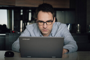 Thoughtful businessman think of online project looking at laptop at workplace, programmer writes a program at home computer, student search new idea inspiration in office cafe