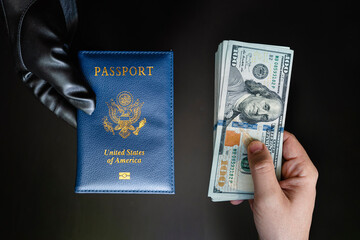 Hands holding passport USA and us dollar bills. passport issuance. Forgery of documents, a criminal concept, black market of American passports - obrazy, fototapety, plakaty