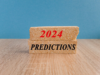 2024 predictions symbol. Concept red words 2024 predictions on brick blocks. Beautiful wooden table, blue background. Business concept. Copy space. - obrazy, fototapety, plakaty