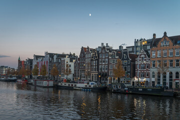 Obraz premium Morning half moon over Amsterdam canal and houses