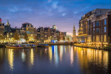 Fototapeta na wymiar Evening waterfront of Amsterdam with city lights