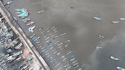 Fototapeta premium aerial view fishing pier. wooden boat anchored at Muncar fishing pier, Banyuwangi, Indonesia.