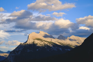 The iconic Mount Rundle stands near Banff, Alberta. Majestic Rocky Mountain landscape with the imposing peak. A breathtaking scene capturing the essence of Canada's natural beauty. Perfect for travel,