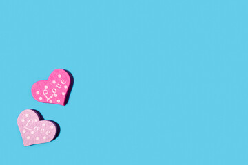 Wooden heart on a pastel blue background. Concept for Valentine's Day, World Women's Day, Mother's Day. Romantic flat composition.