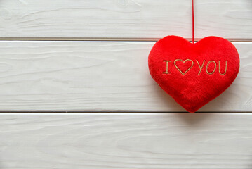 A symbol of love on white wooden background
