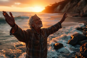 Grandpa smiling at sunset by the sea with arms up, happy active seniors images