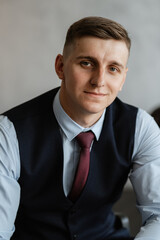 portrait of a cheerful groom in a blue suit