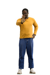 Fototapeta premium A man in a yellow sweater on a White background shows a stop sign