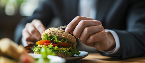 Businessman eating sandwich and vegetables for lunch. Creative Banner. Copyspace image