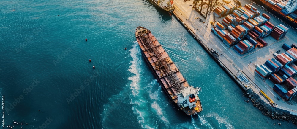 Poster aerial drone ultra wide top down panoramic photo with copy space of container tanker anchored in loa