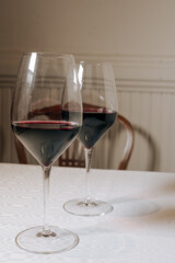 red wine  two glasses on Restaurant table old fashion chair behind
