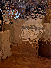 forged sheet of copper, bronze, gold with a wavy shiny metal surface. background or wall covering....