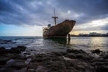 A rusty and dilapidated ship near the port of Arrecife, Canary Islands. Spain.