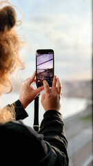 Woman taking photo with a smartphone