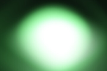 White light texture with green outline spreading round on dark background.