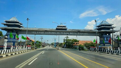 Tegal, Indonesia - January, 2024 : welcome gate of Tegal regency, with blue sky as background