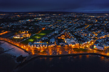 Aerial view on Salthill area of Galway city, Ireland. Night scene with illuminated roads, buildings...
