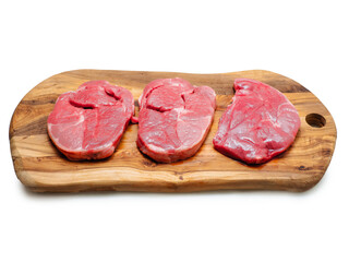 Fresh juicy boneless lamb steak on a wooden board. Premium meat product for cooking. High quality meat cut. Food chain.