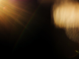 Abstract lens flare on dark background for special lighting effect and graphic design.