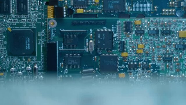 Electronic boards with many different microcircuits and other radio components show the complexity of the products of the modern electronics industry. Closeup. Macro. Shot in motion