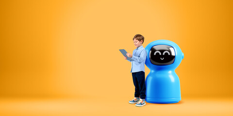 Child with tablet, standing near robot on copy space orange background