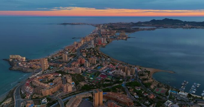 Establishing aerial shot of the city of manga, in La Manga del Mar Menor Murcia impressive view of the buildings and beaches. Spectacular travel destination La Manga