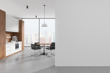 Stylish office interior with kitchen cabinet and eating table. Mockup wall