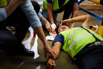 senior worker fell over and his head is bleeding on the floor in the factory