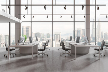 Naklejka premium Office coworking interior with pc monitors in row, panoramic window