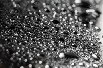 Drops of water on a color background. Selective focus. Gray