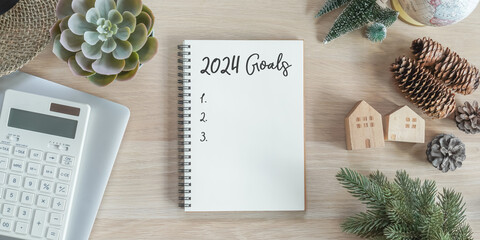 2024 goals new year resolutions on blank note book memo reminder wish list of yearly planner, action plan for work-life balance, good financial health, happy home family, travel aims on office desk - obrazy, fototapety, plakaty