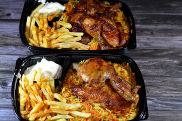 Arabic Syrian cuisine of machine grilled barbecued chicken with colorful Basmati rice and French...