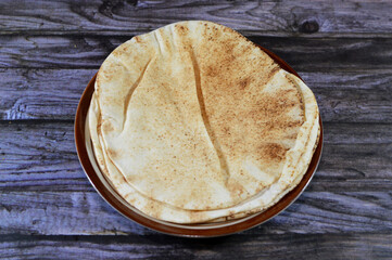 Traditional Shami flat bread with wheat and flour, small Aish Shamy or small pita bread baked in...