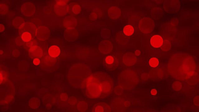 Red glowing bokeh particles animation.Red background.Moving bubbles colorful blurred animation backdrop.christmas and valentine's day background.